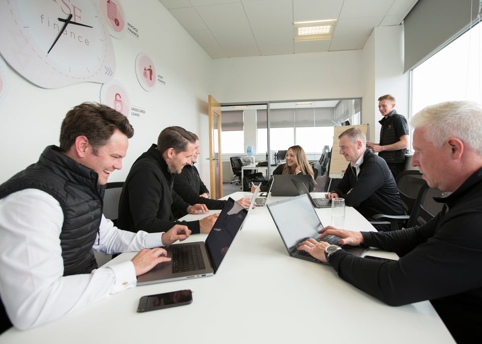 TSF Team working around an office table