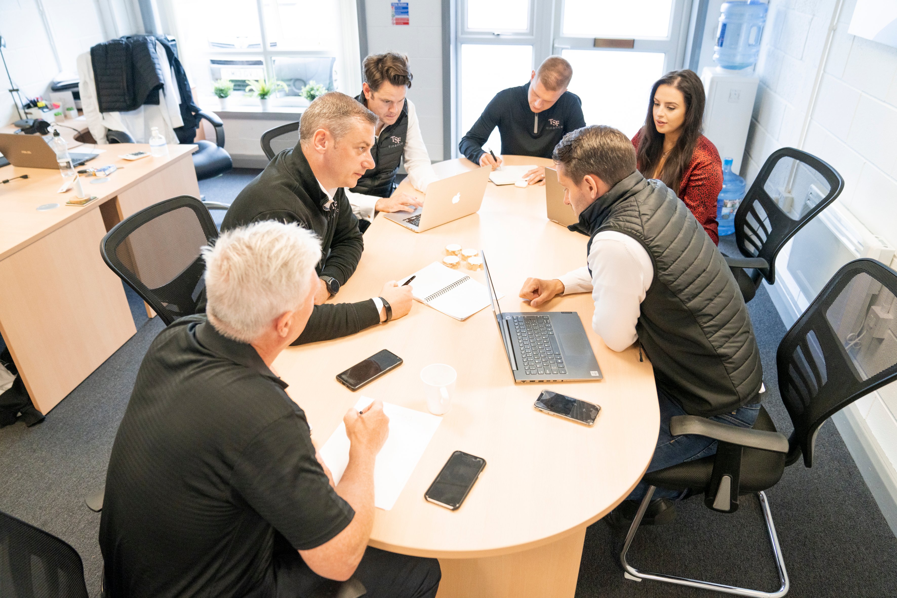 TSF team conversing around table