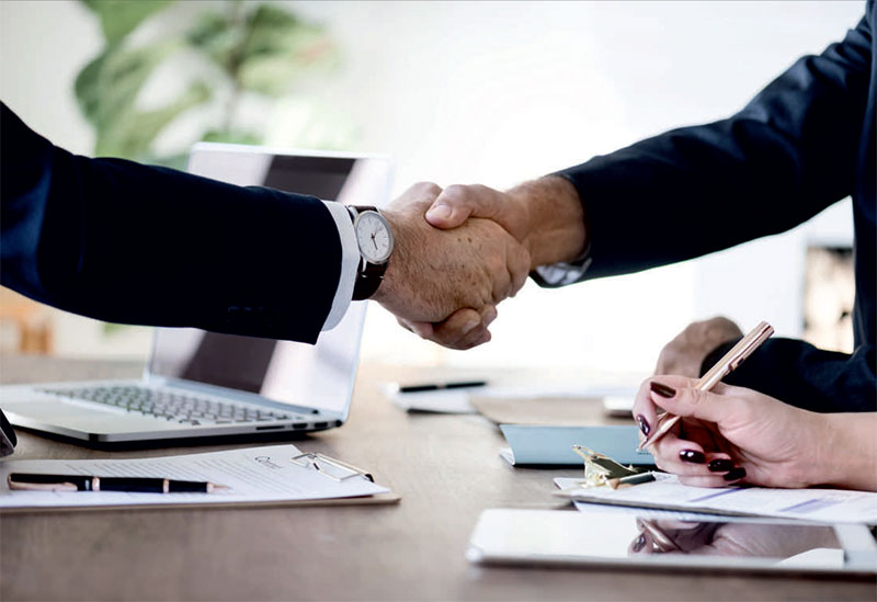 Two people shaking hands after an invoice finance agreement.